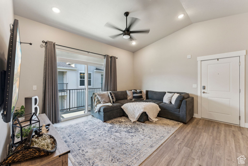Living area featuring a ceiling fan, vaulted ceiling, light wood-style flooring, and recessed lighting