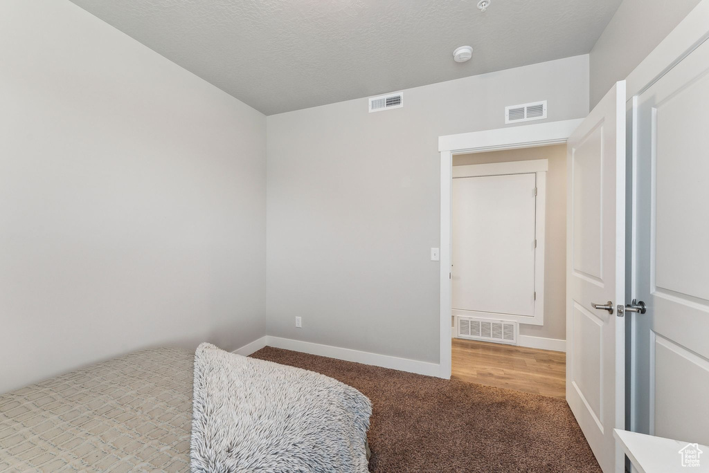Bedroom featuring carpet flooring and baseboards