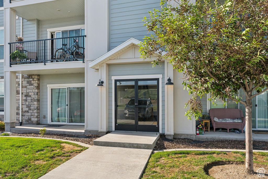Entrance to property featuring french doors and a balcony