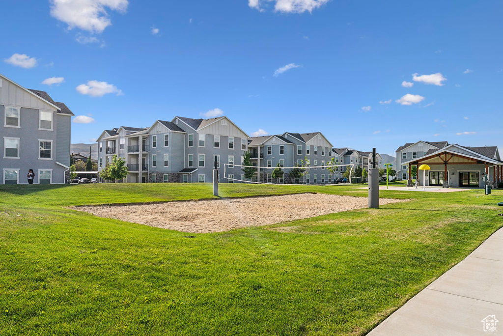 Surrounding community featuring a residential view, volleyball court, and a lawn