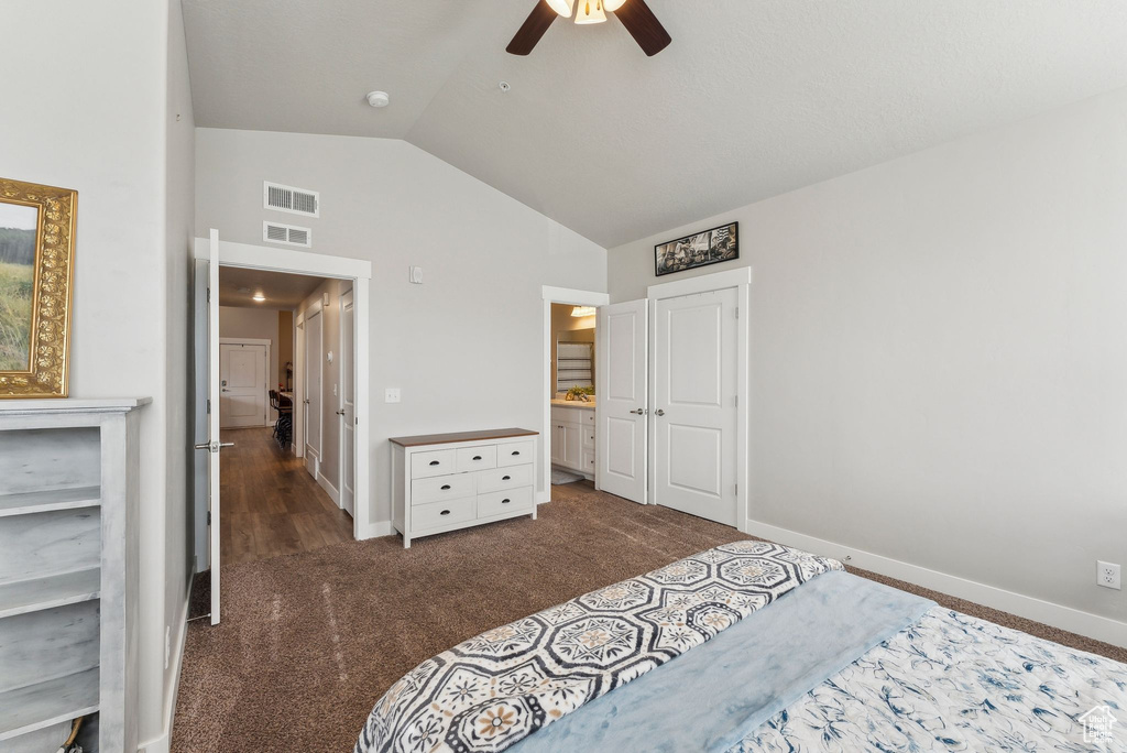 Carpeted bedroom with lofted ceiling, baseboards, ceiling fan, and a closet