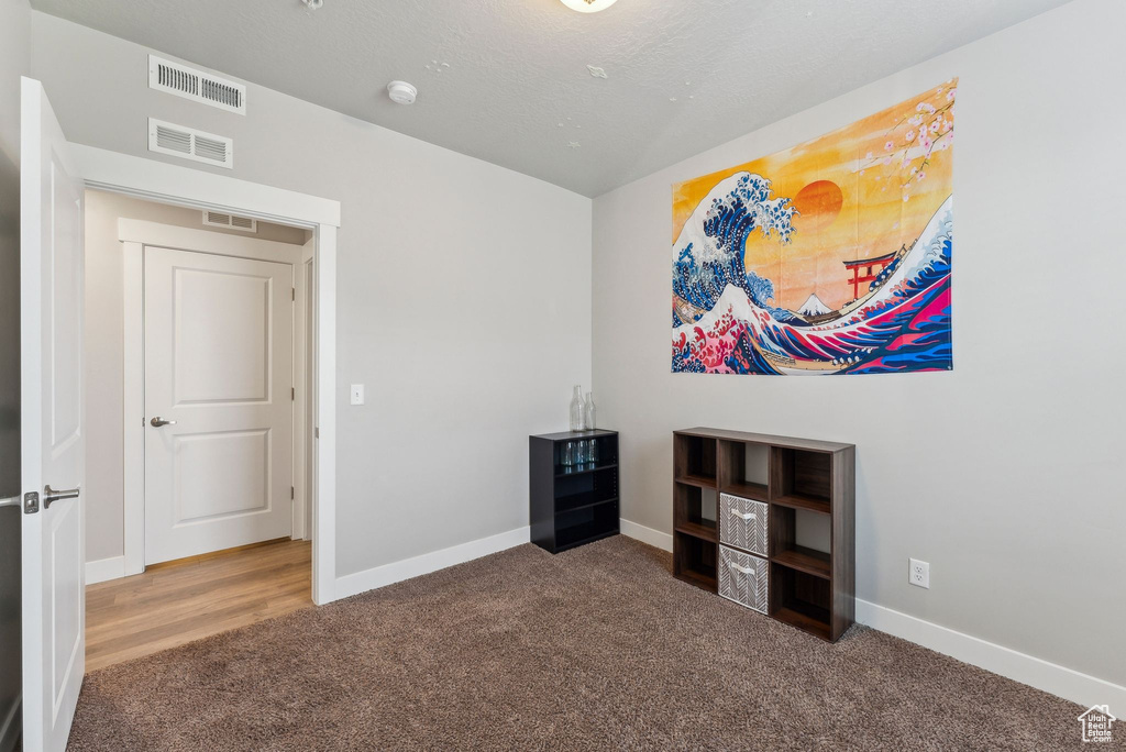 Miscellaneous room featuring carpet flooring and baseboards