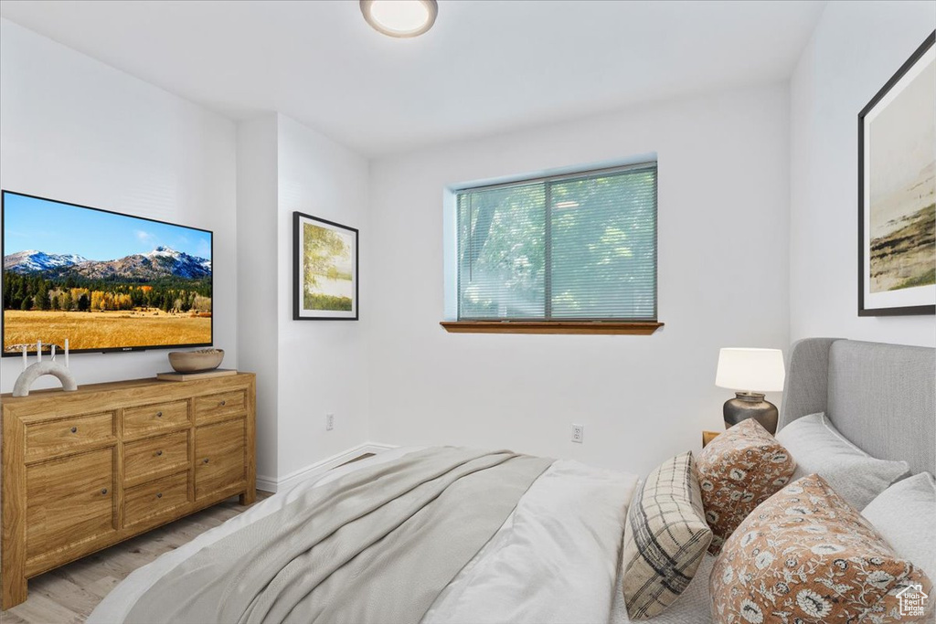 Bedroom featuring light wood-style flooring and baseboards