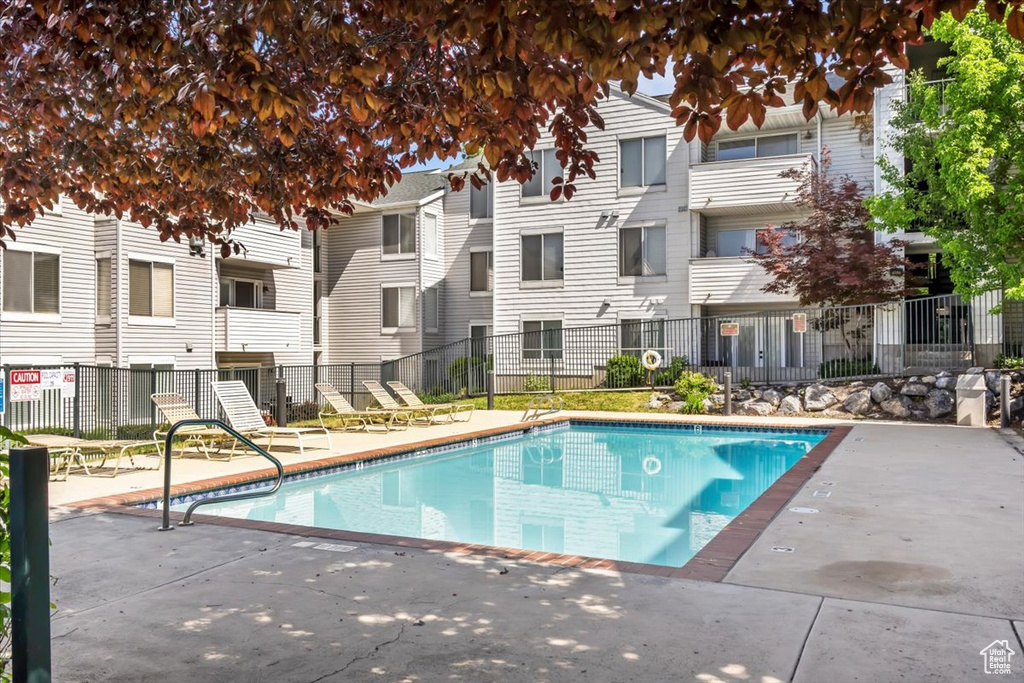Community pool featuring a patio