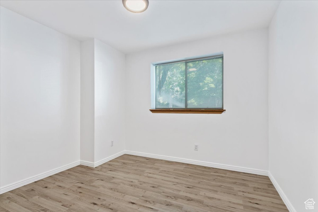 Spare room with wood finished floors and baseboards