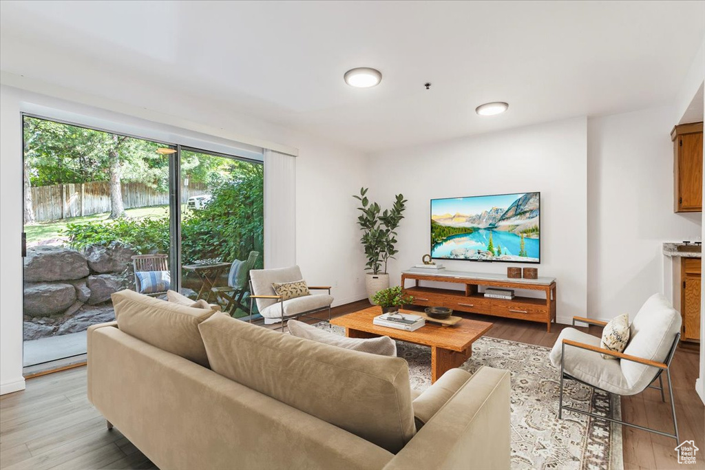 Living room with light wood-style flooring and baseboards