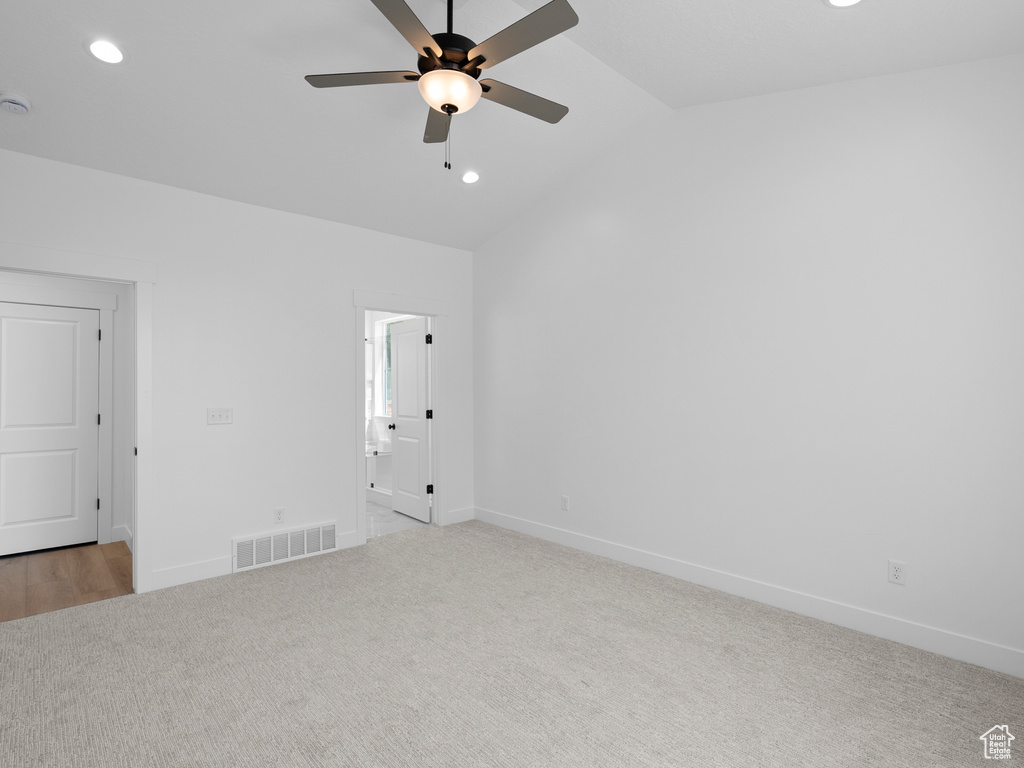 Unfurnished room featuring light carpet, recessed lighting, ceiling fan, vaulted ceiling, and a smoke detector