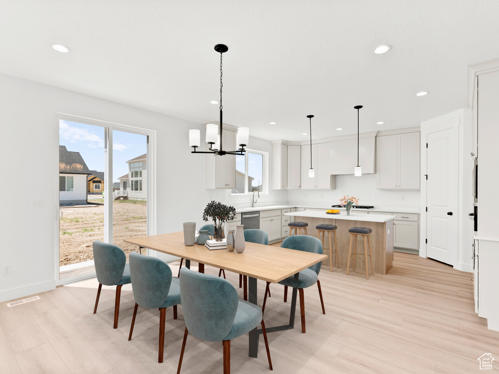 Dining room with a chandelier, light wood-type flooring, and recessed lighting