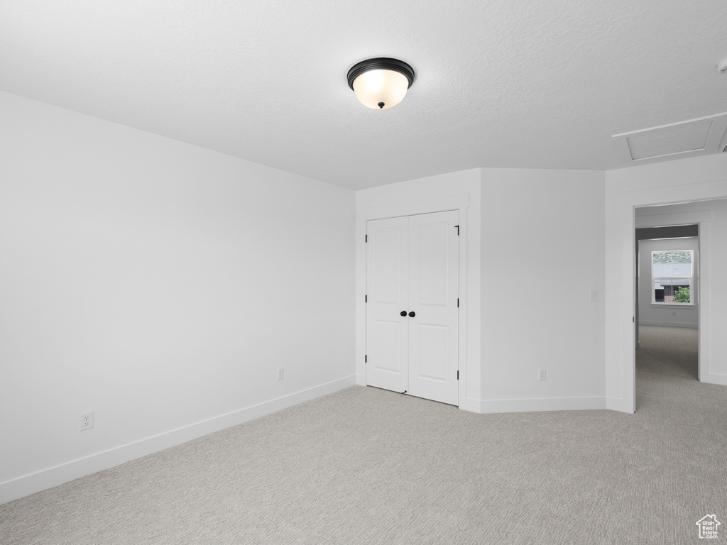 Empty room featuring carpet floors and baseboards