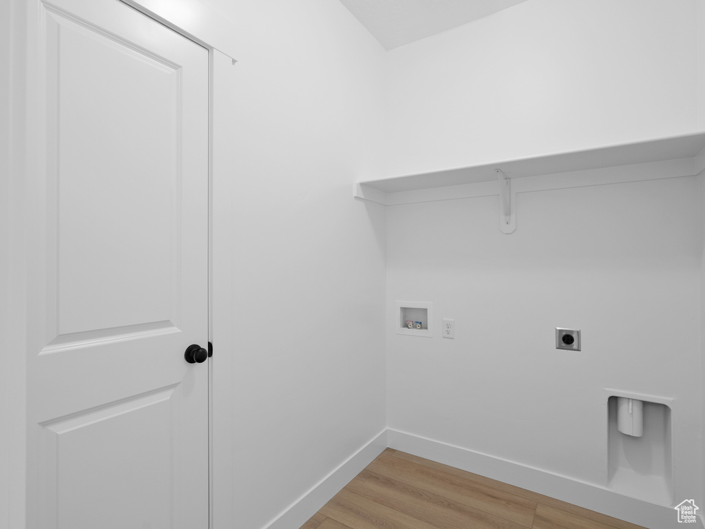 Laundry room with washer hookup, hookup for an electric dryer, and light wood-style flooring
