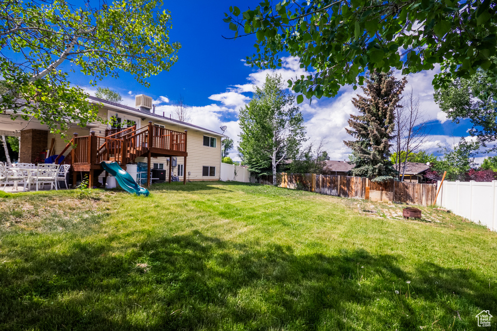 View of yard featuring an outdoor fire pit and a playground