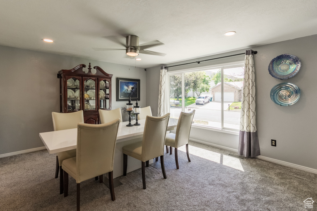 Dining room featuring carpet flooring, a ceiling fan, baseboards, and recessed lighting