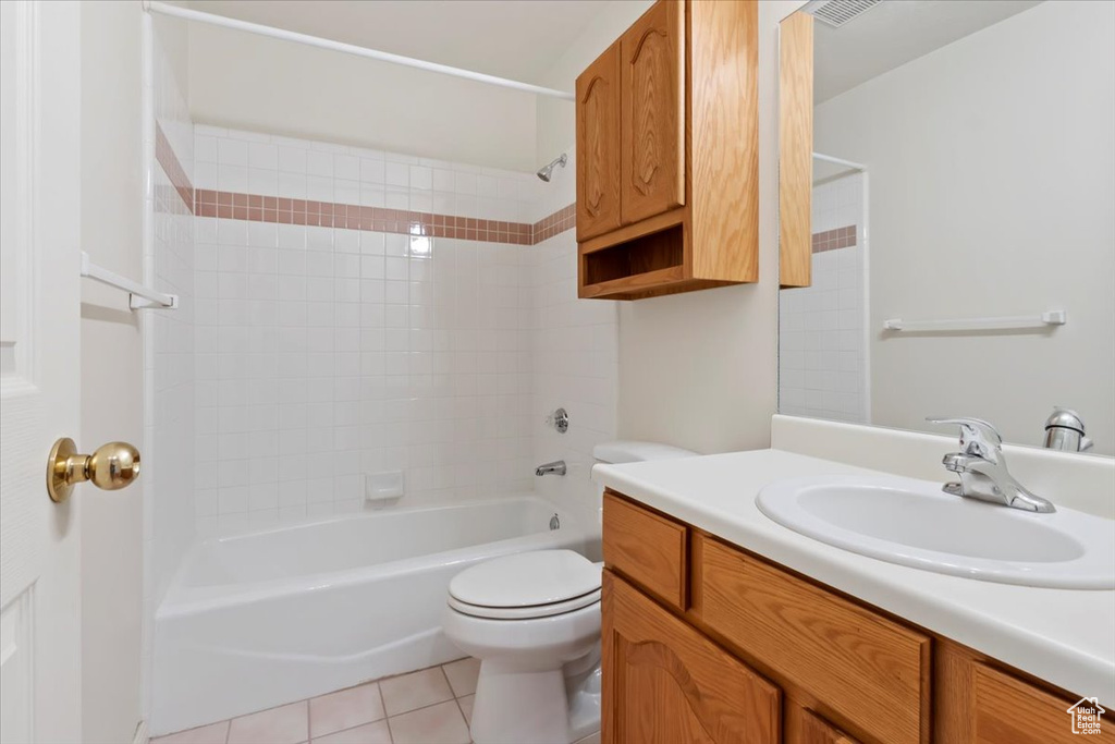 Full bathroom featuring vanity, tub / shower combination, toilet, and tile patterned floors