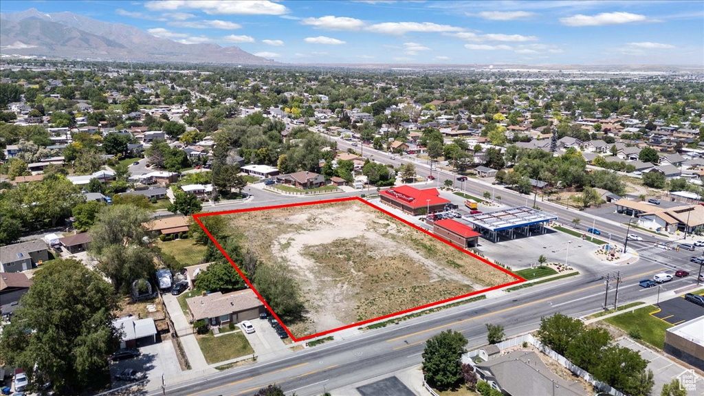 Aerial overview of property\'s location with property boundaries highlighted and a mountain backdrop