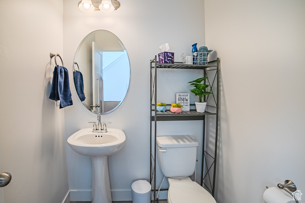 Bathroom with toilet and baseboards