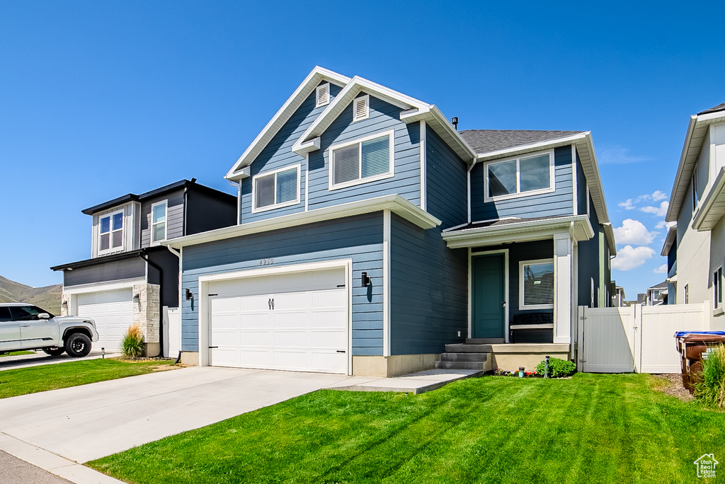 View of front of house featuring an attached garage and driveway