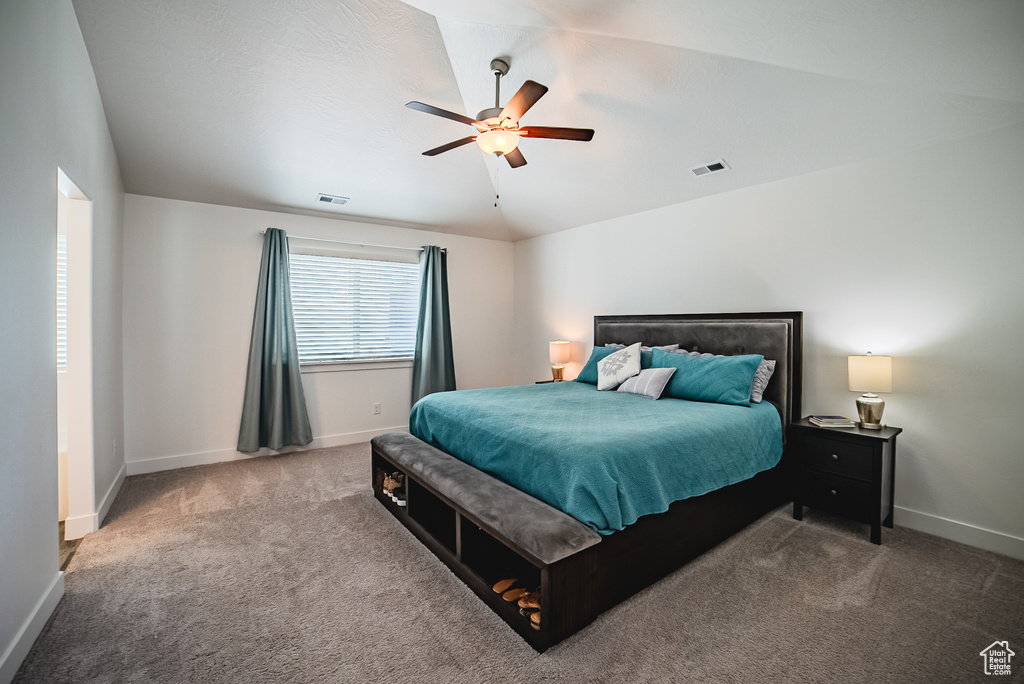 Bedroom with carpet, baseboards, and a ceiling fan
