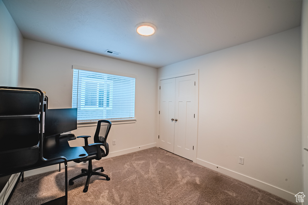 Carpeted office featuring baseboards