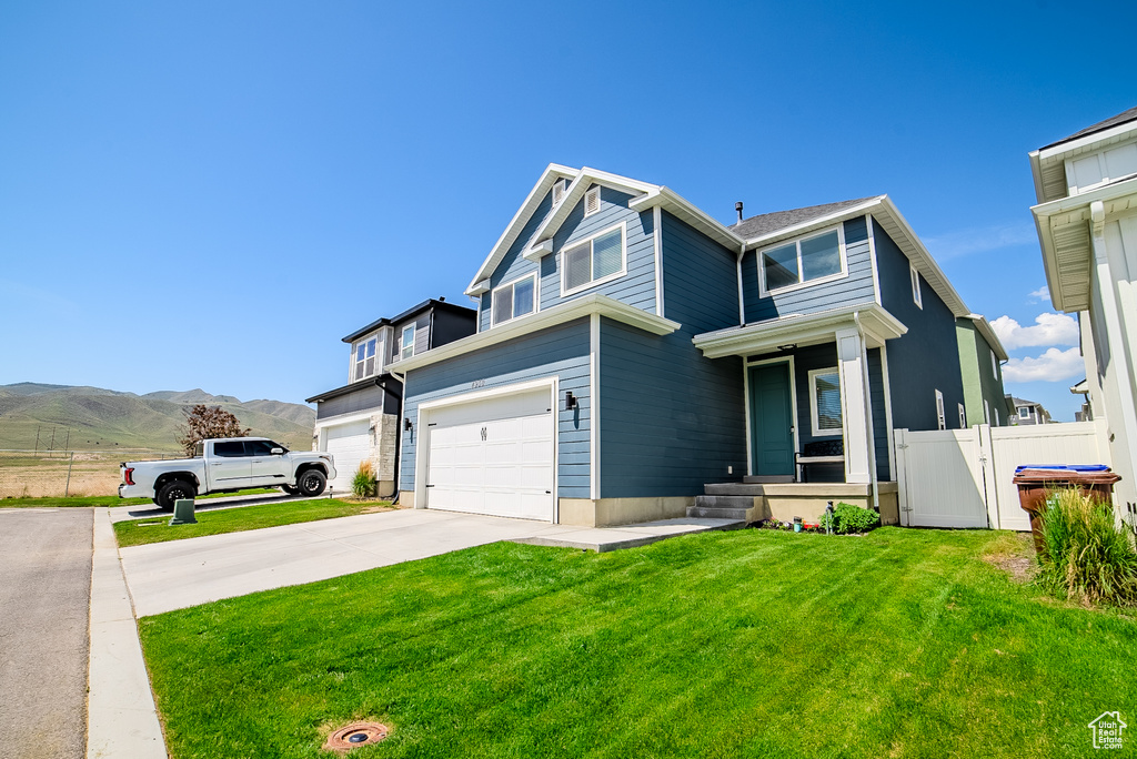 Traditional-style house featuring driveway, an attached garage, and a mountain view