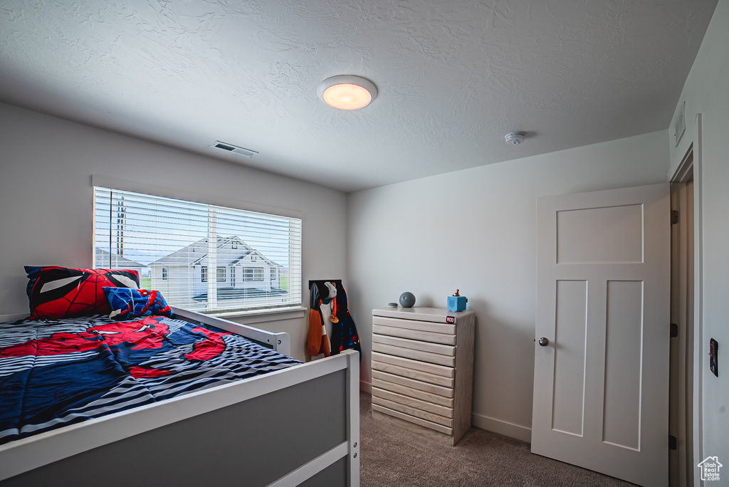 Bedroom with carpet and baseboards