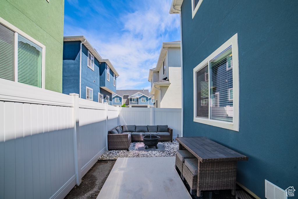 Fenced backyard with outdoor lounge area, a patio, and a residential view