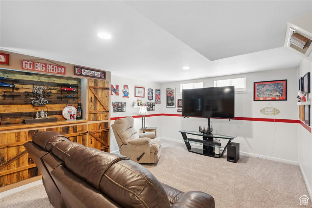 Carpeted living room with recessed lighting and baseboards