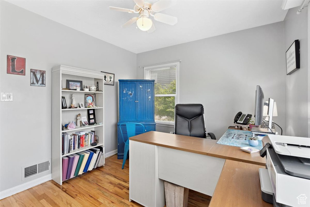 Office with ceiling fan, light wood-type flooring, and baseboards