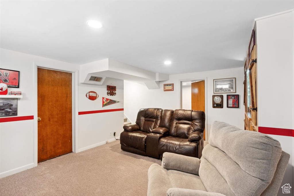 Carpeted living room featuring baseboards and recessed lighting