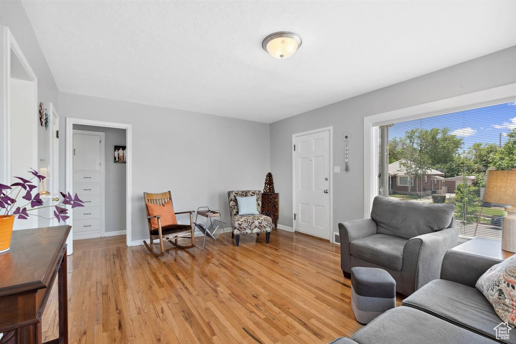 Living area featuring light wood-style floors and baseboards