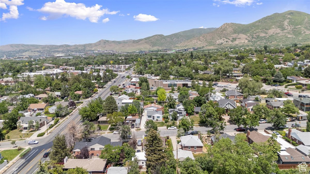 Aerial overview of property's location with mountains and nearby suburban area
