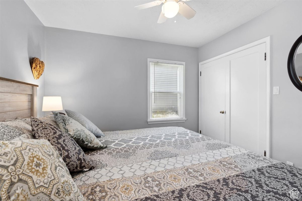 Bedroom with a ceiling fan and a closet