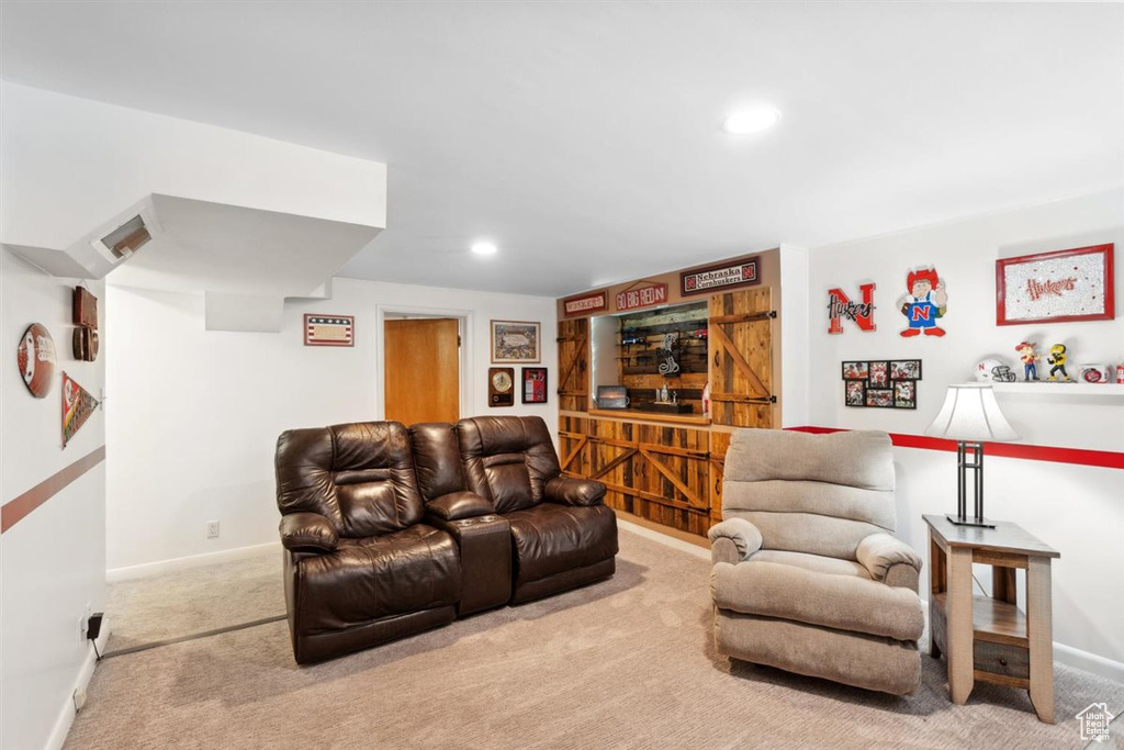 Carpeted living room featuring baseboards and recessed lighting