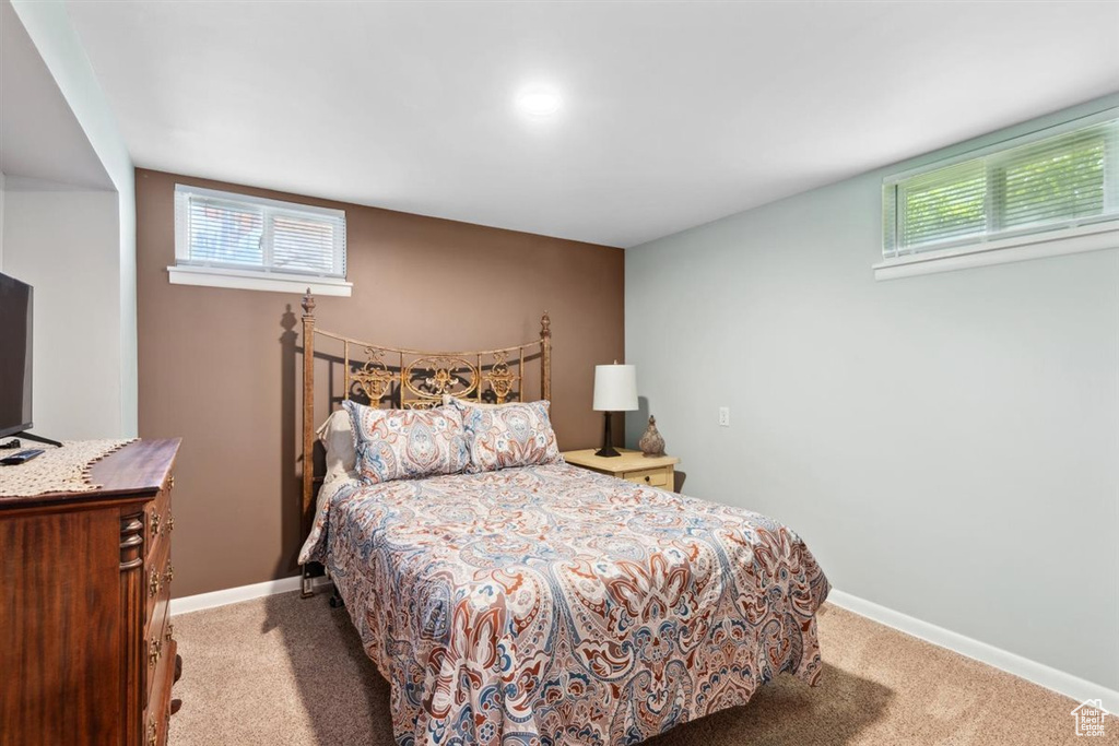 Carpeted bedroom featuring baseboards