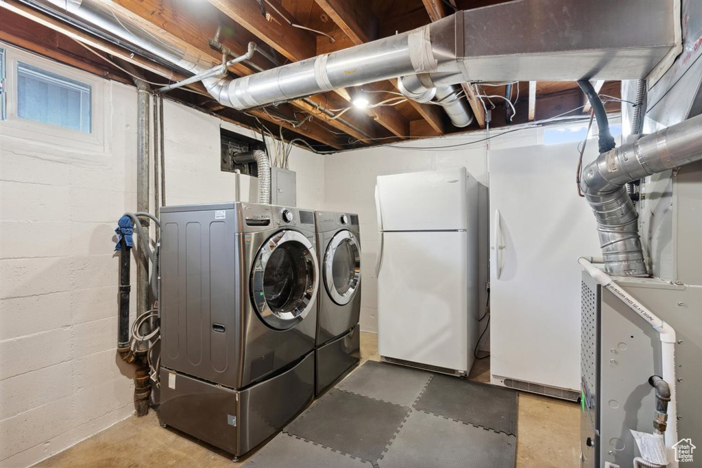 Laundry area with washer and dryer and concrete block wall