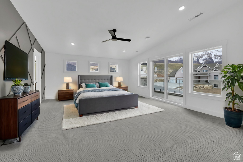 Bedroom with light colored carpet, recessed lighting, ceiling fan, vaulted ceiling, and baseboards