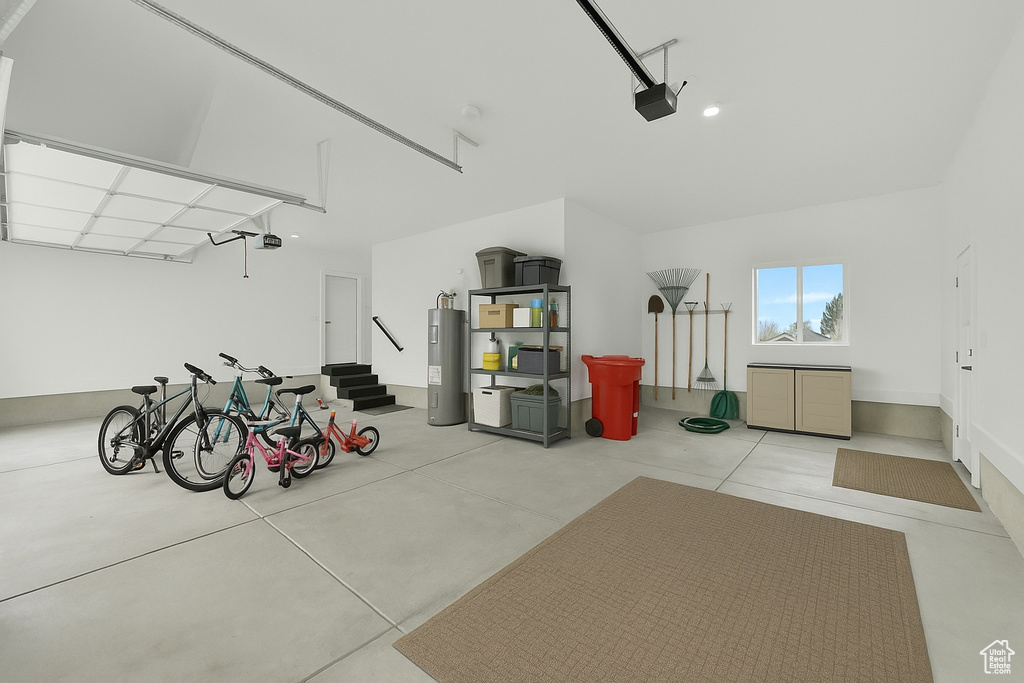 Garage featuring water heater and a garage door opener