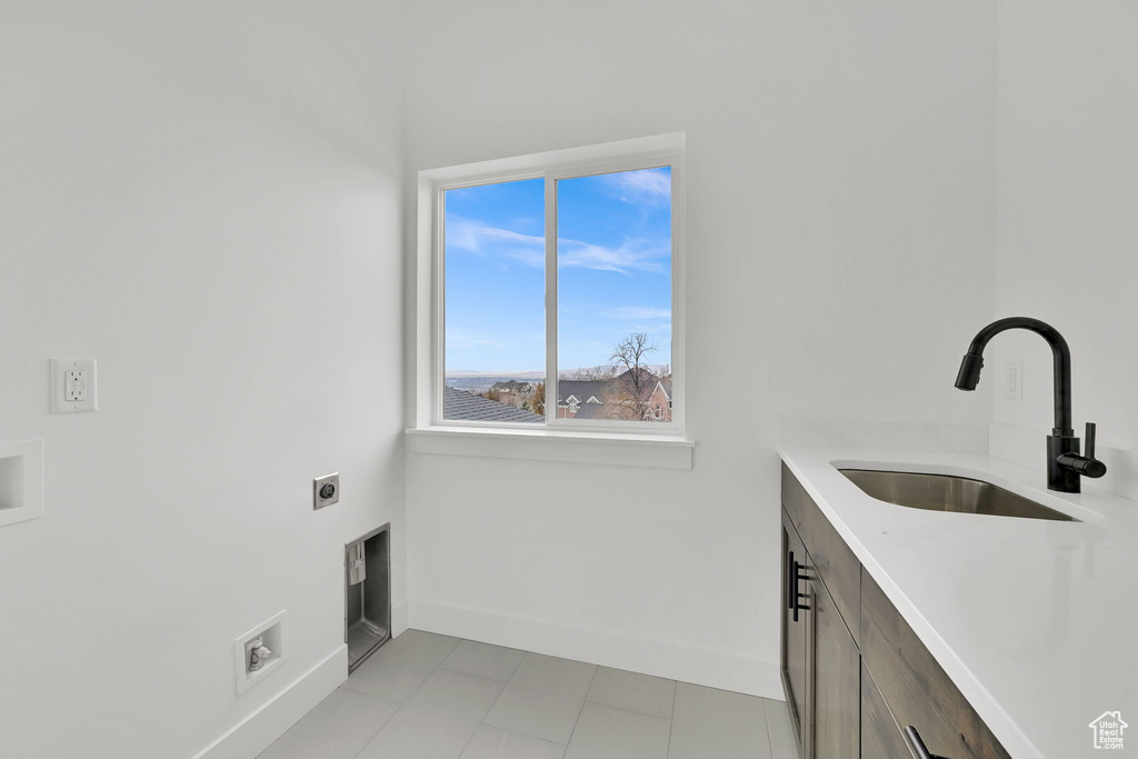 Laundry room featuring electric dryer hookup, baseboards, cabinet space, and washer hookup