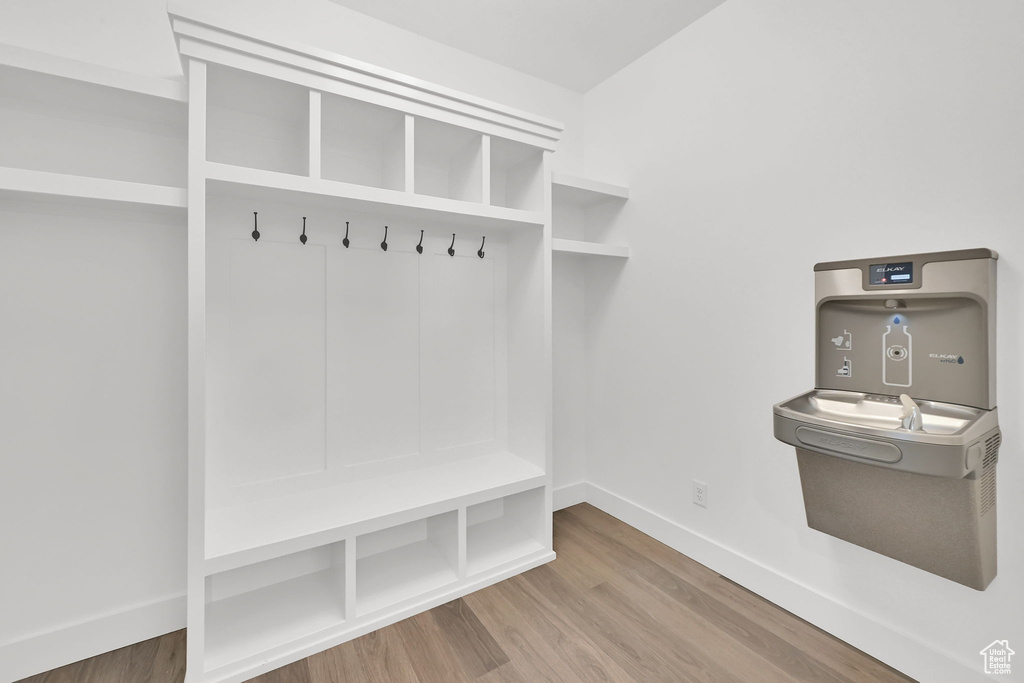 Mudroom featuring baseboards and wood finished floors
