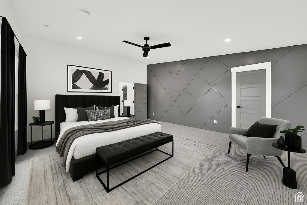 Bedroom with light colored carpet, a decorative wall, recessed lighting, ceiling fan, and an accent wall