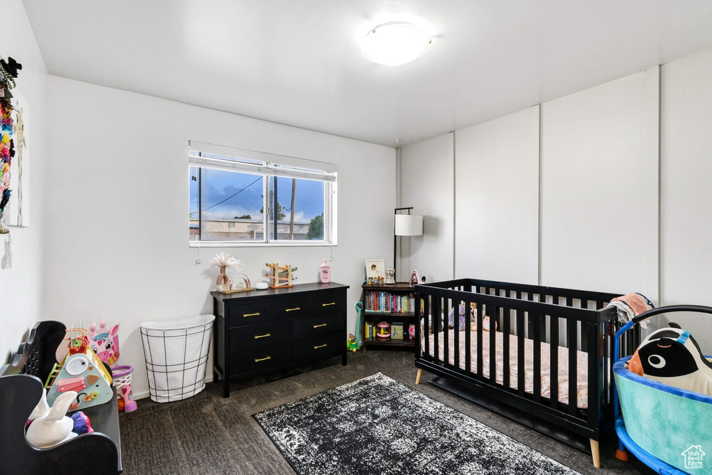 Bedroom featuring dark colored carpet