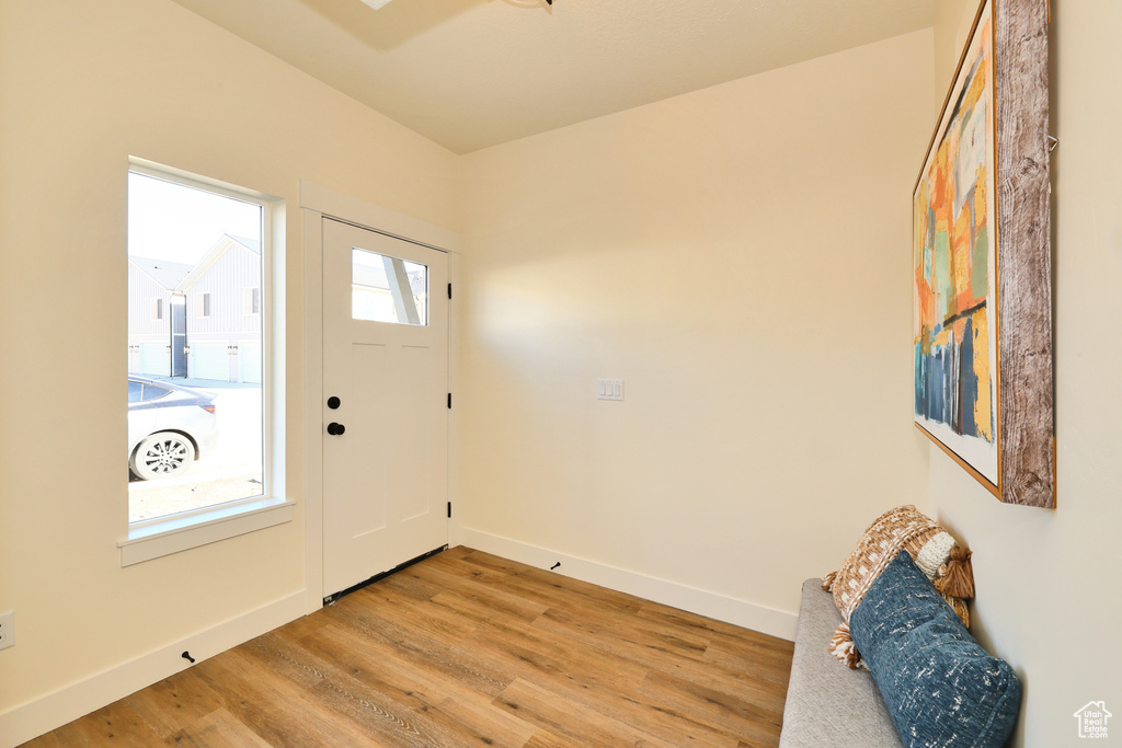 Entryway with light wood finished floors and baseboards