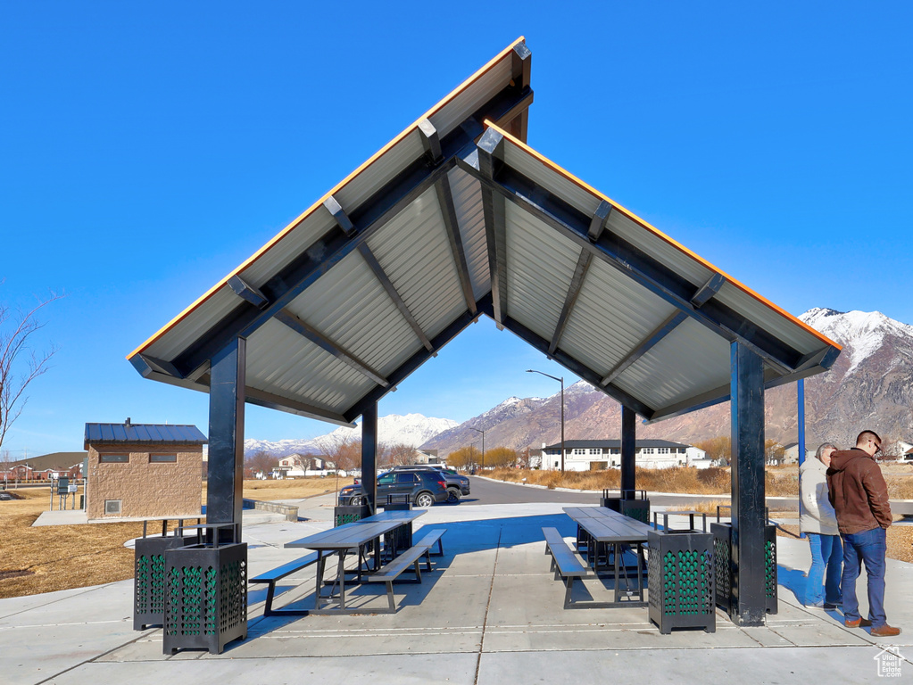 View of community with a mountain view and a patio area