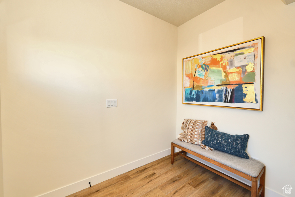 Hall featuring baseboards and wood finished floors