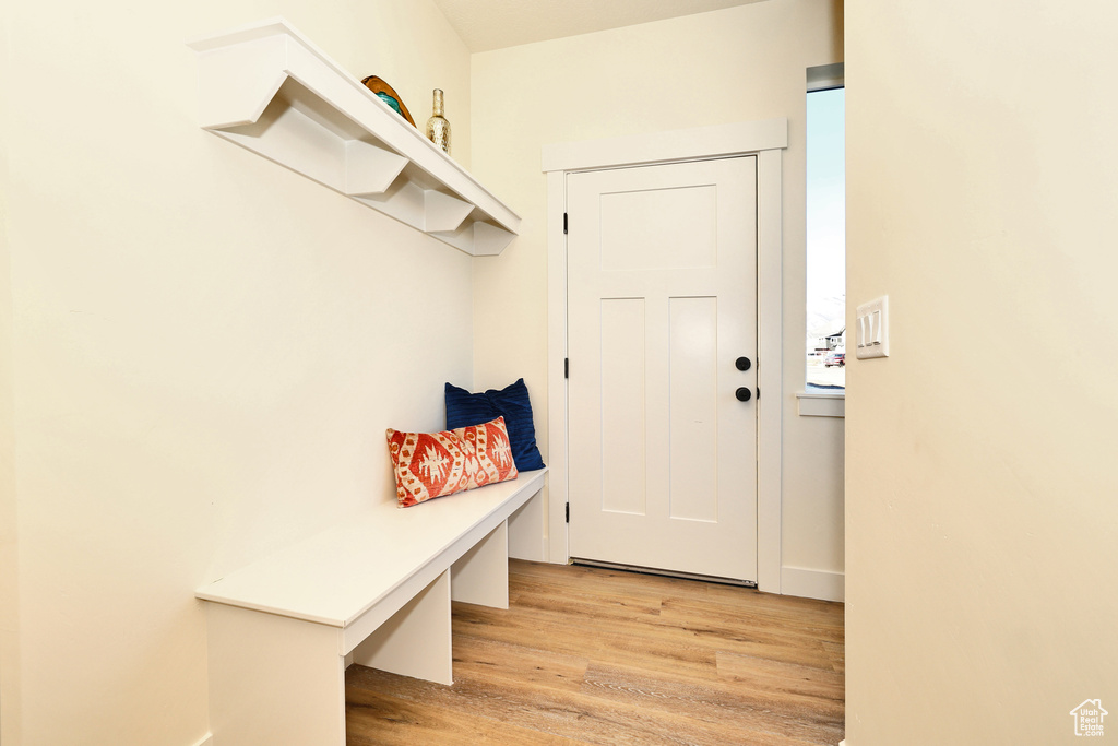 Mudroom with light wood-style flooring and baseboards