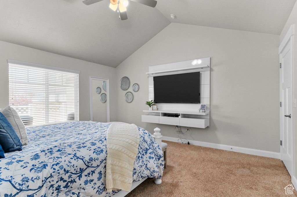 Bedroom with carpet floors, vaulted ceiling, ceiling fan, and baseboards
