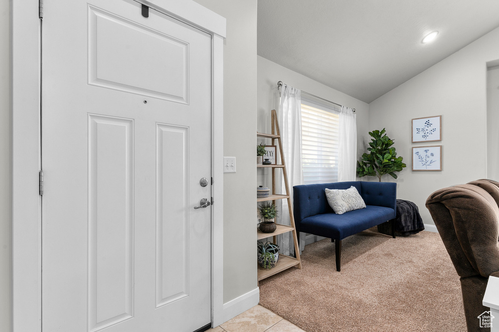 Carpeted office featuring baseboards and lofted ceiling