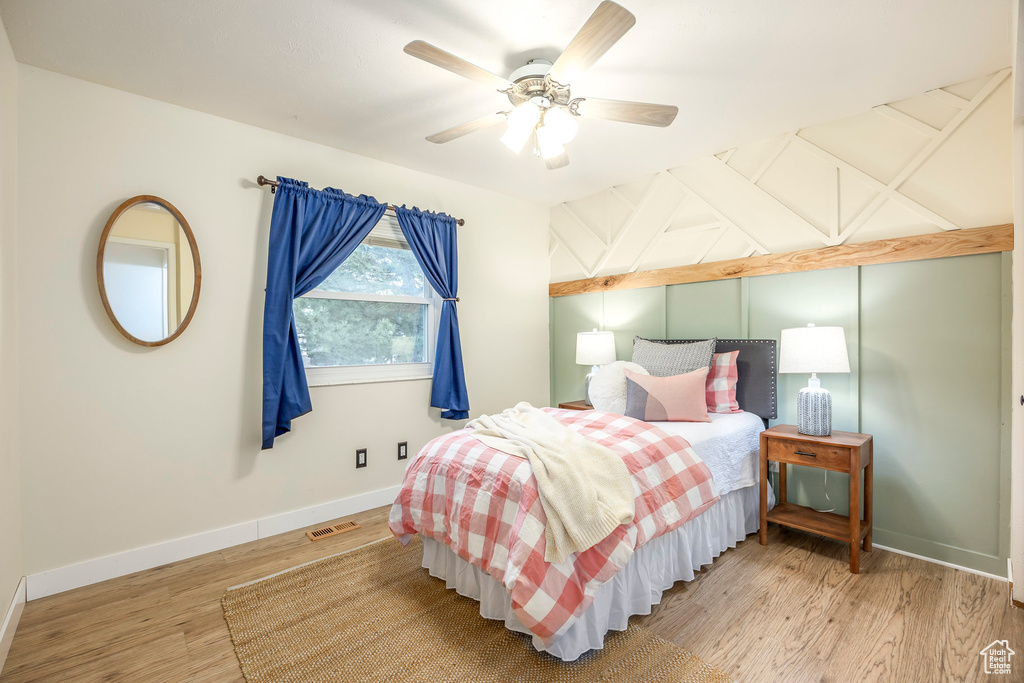 Bedroom featuring wood finished floors, baseboards, and a ceiling fan