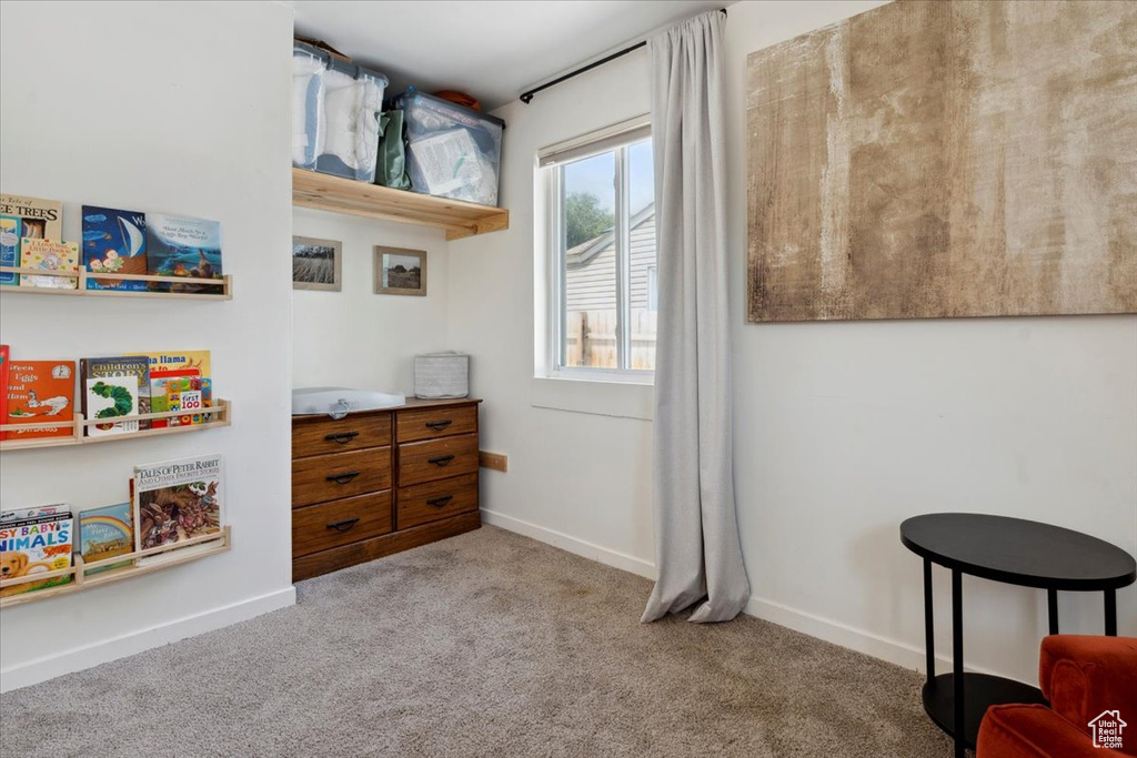 Living area with carpet flooring and baseboards