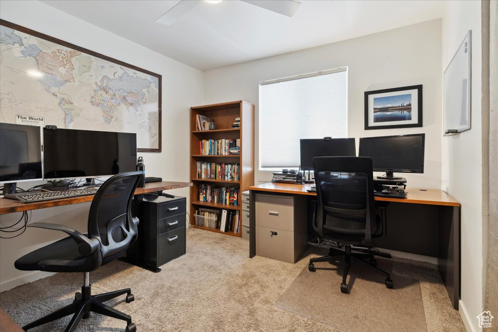 Home office featuring light colored carpet