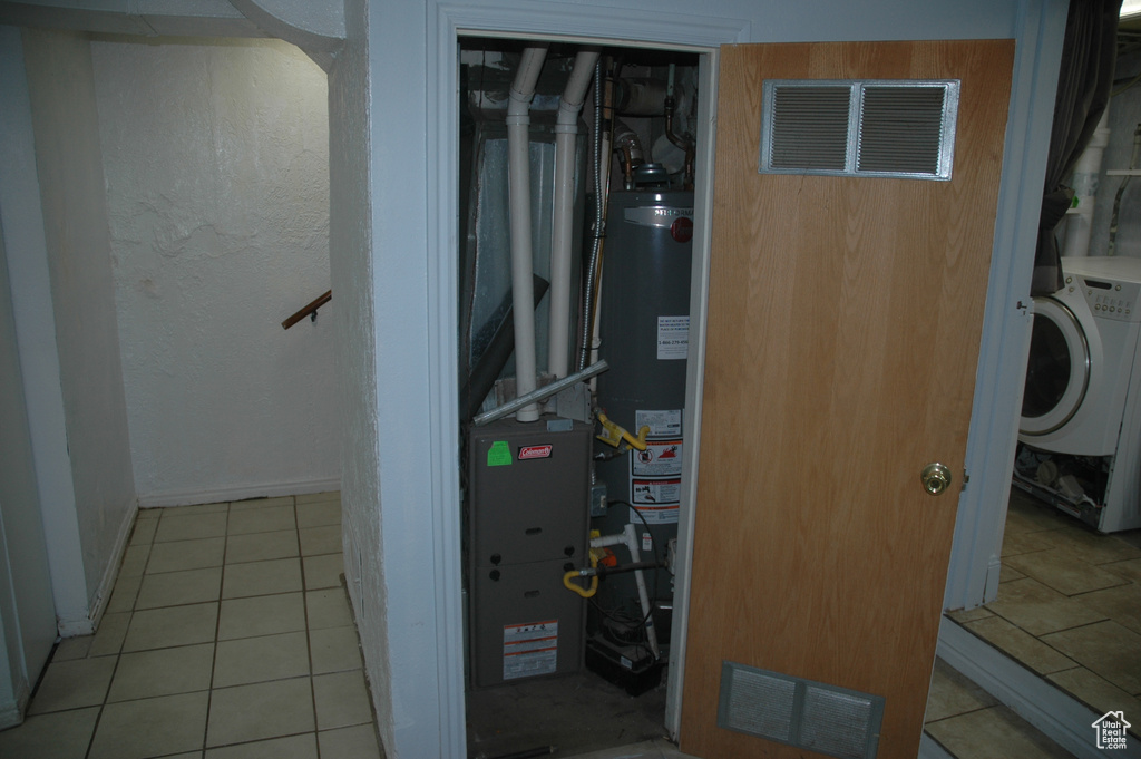 Utility room featuring washer / dryer and gas water heater